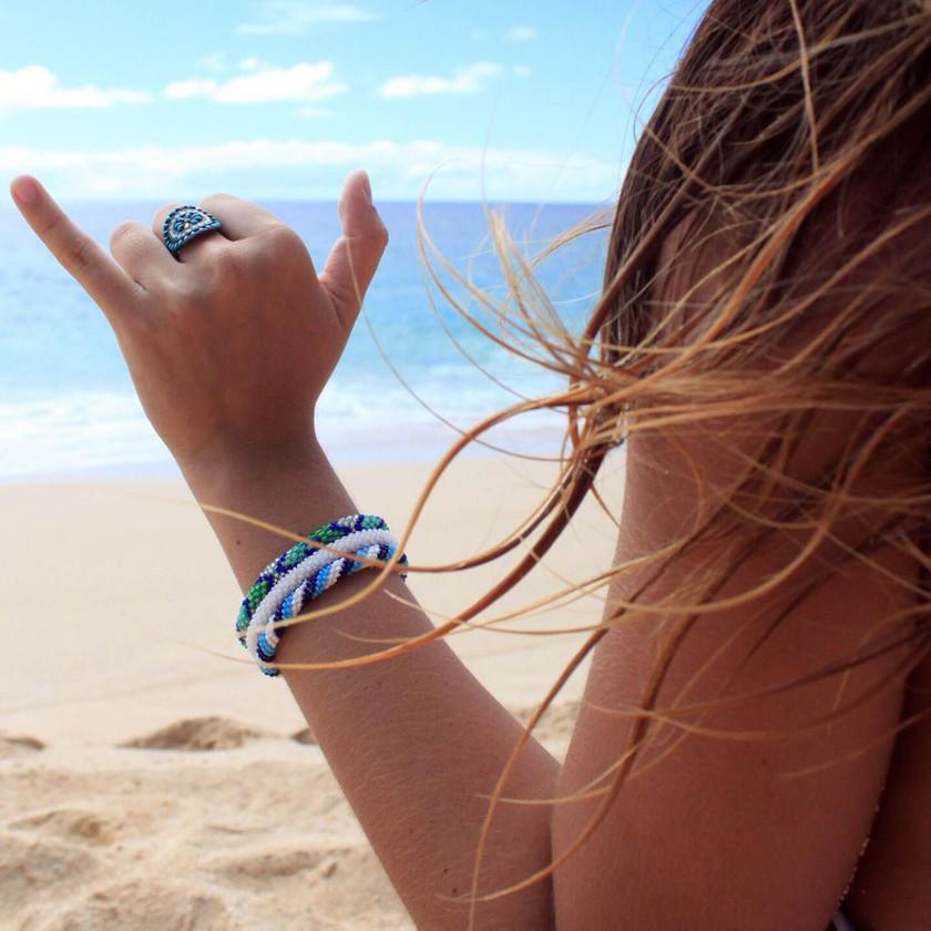 A stack of bohemian style sashka co. glass beaded bracelets. 