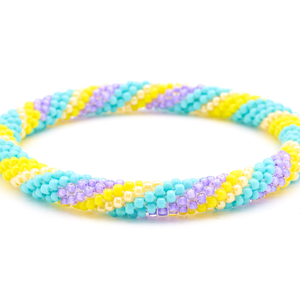 Handmade Beaded friendship bracelet with turquoise, yellow, and purple glass beads. Crafted by artisans in Nepal for Sashka Co. 
