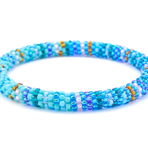 Sashka Co.  Shades of Blue, Teal, Turquoise, Amber, Light Purple, Aqua Current Bracelet. Handmade glass bead bracelet from Nepal, featuring a roll design.
 