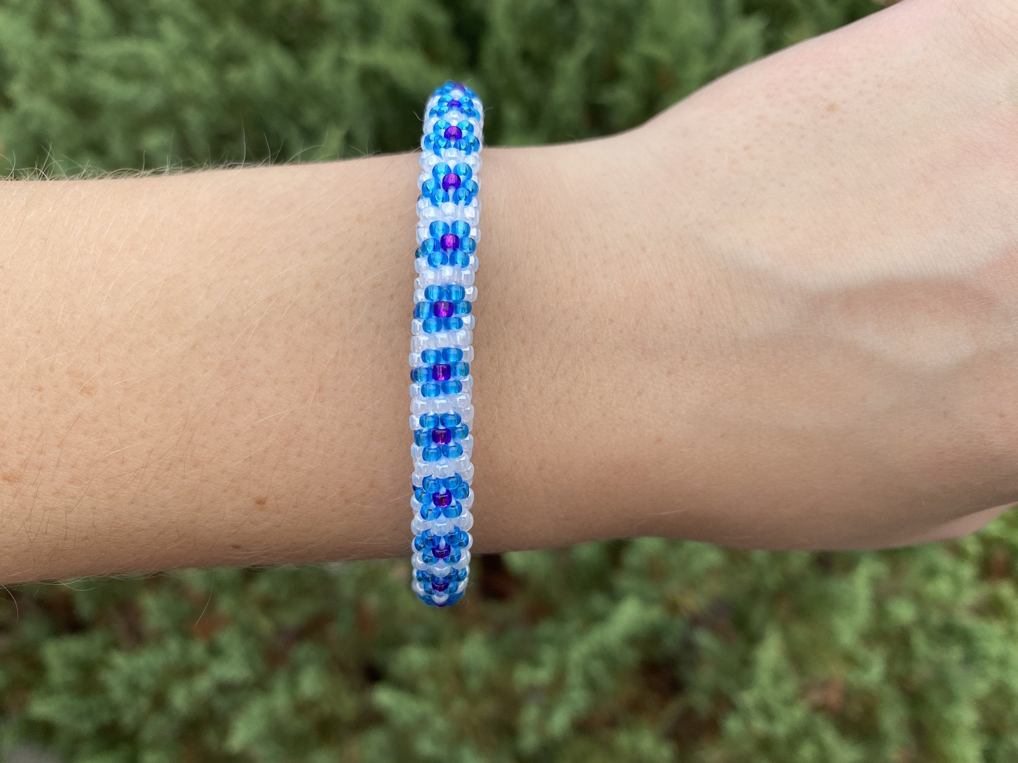 Sashka Co. Blue , White , Purple Bracelet. Handmade glass bead bracelet from Nepal, featuring a roll design.