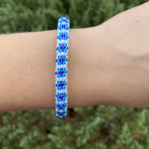Sashka Co. Blue , White , Purple Bracelet. Handmade glass bead bracelet from Nepal, featuring a roll design.