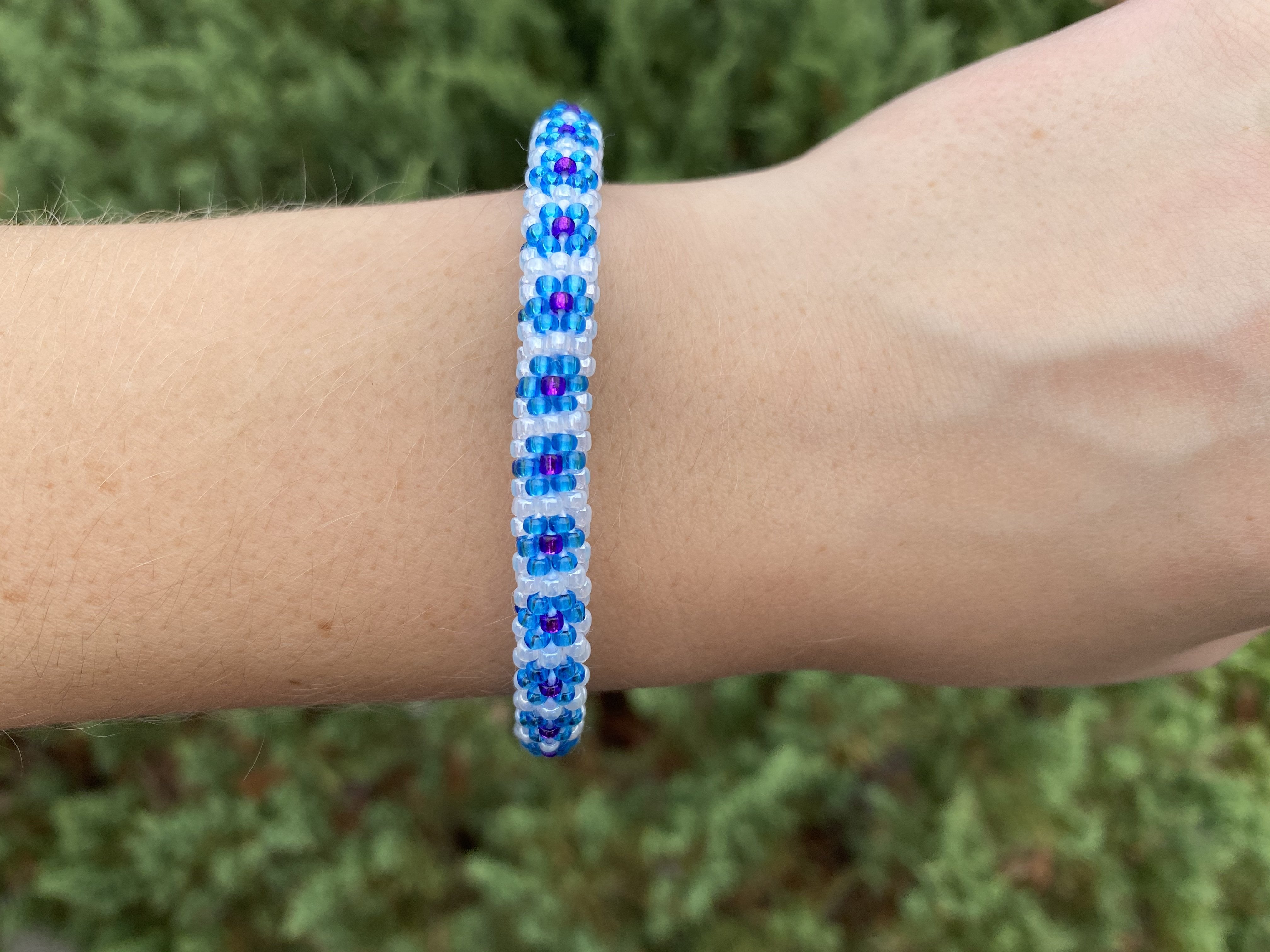 Sashka Co. Blue , White , Purple Bracelet. Handmade glass bead bracelet from Nepal, featuring a roll design.