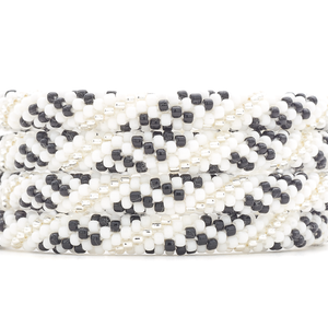 Handmade beaded friendship bracelet with white, black, and clear glass beads. Crafted by artisans in Nepal for Sashka Co.