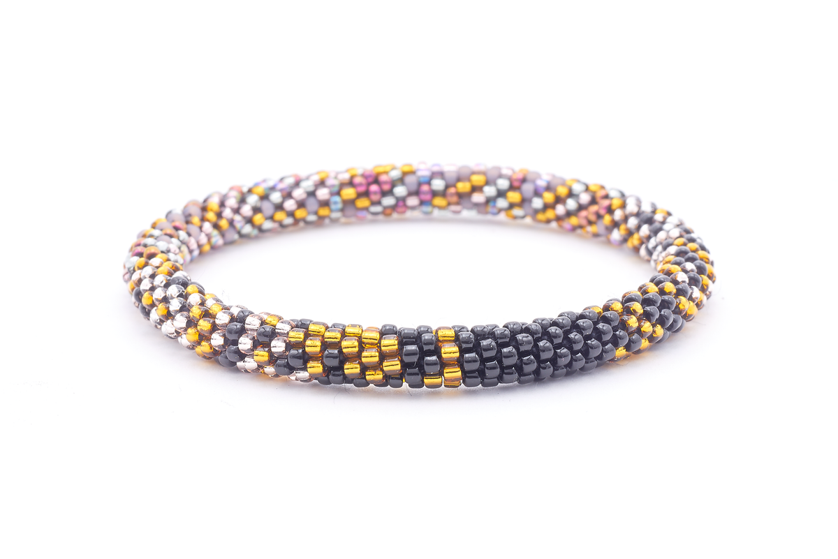 Sashka Co. handmade glass beaded friendship bracelet with black, gold, silver, iridescent purple, and matte gray glass beads in a confetti mixed pattern. Crafted in Nepal by skilled artisans.