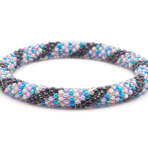 Sashka Co handmade beaded friendship bracelet with blue, black, light purple, and iridescent mauve glass beads. Crafted in Nepal by skilled artisans.

