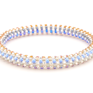 Sashka Co. handmade glass beaded friendship bracelet with blue, clear, silver, brown, and light purple glass beads. Crafted in Nepal by skilled artisans.