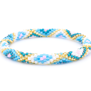 Sashka Co. handmade beaded friendship bracelet with blue, teal, white, champagne gold, and pink glass beads. Crafted in Nepal by skilled artisans in a diamond pattern.