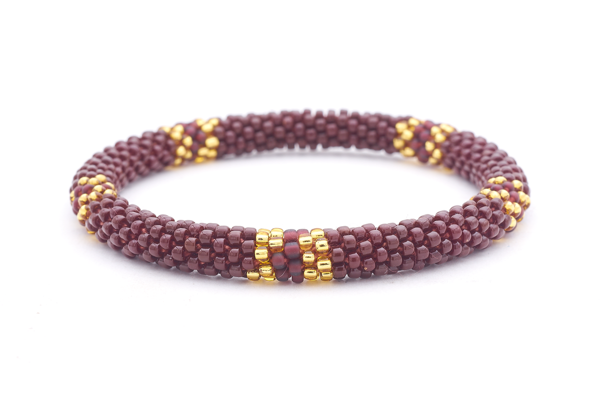 Handmade beaded friendship bracelet with brown, champagne gold, and matte plum glass beads. Crafted by artisans in Nepal for Sashka Co.