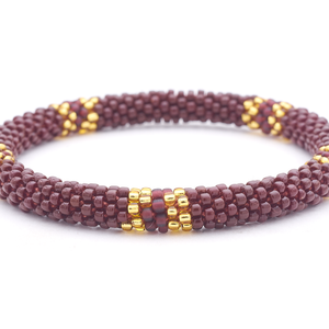 Sashka Co handmade beaded friendship bracelet with brown, champagne gold, and matte plum glass beads. Crafted in Nepal by skilled artisans.