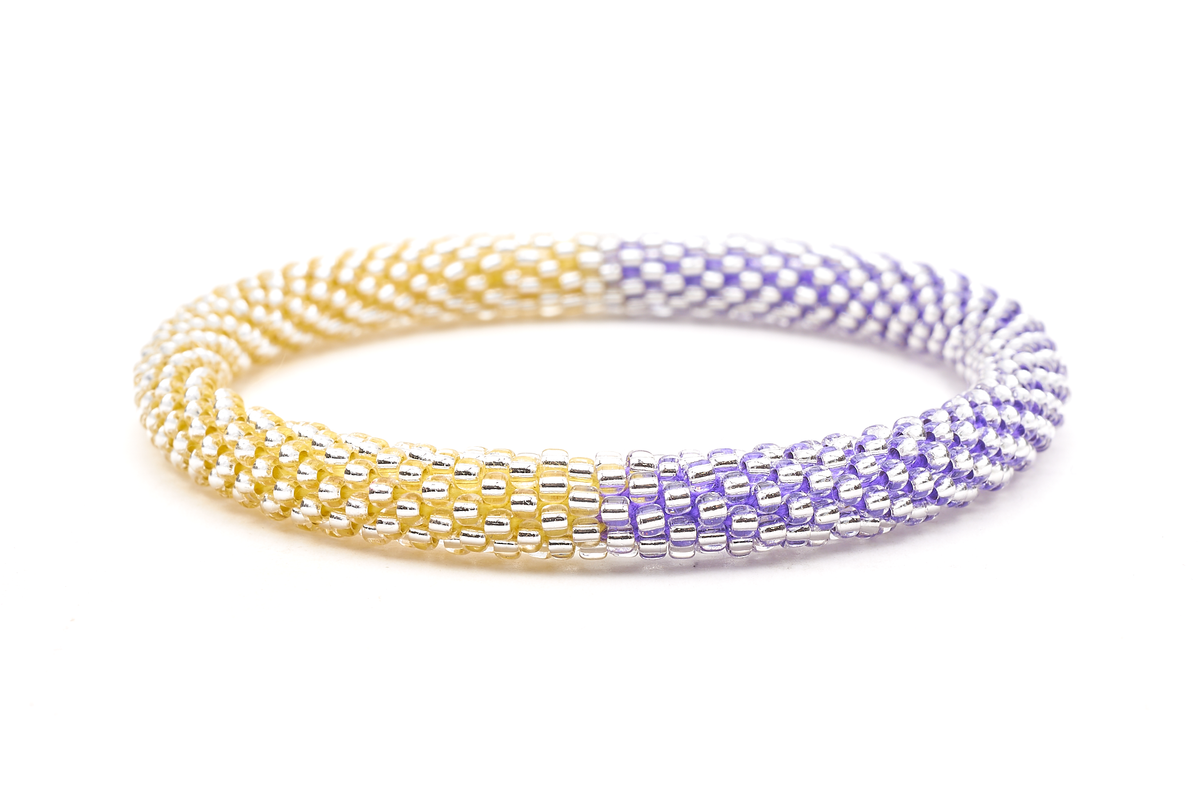 Handmade beaded friendship bracelet with clear glass beads and purple and yellow thread. Crafted by artisans in Nepal for Sashka Co.
 
