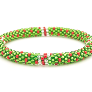 Sashka Co. handmade glass beaded friendship bracelet with green, red, and clear beads in a festive polka dot line pattern. Crafted in Nepal by skilled artisans.
