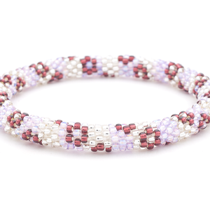 Sashka Co. handmade beaded friendship bracelet with iridescent light purple, clear, and plum glass beads in a flower pattern. Crafted in Nepal by skilled artisans.