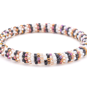 Sashka Co. handmade glass beaded friendship bracelet with iridescent purple, rose gold, white, and black glass beads. Crafted in Nepal by skilled artisans.