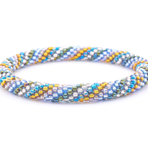 Sashka Co. handmade glass beaded friendship bracelet with iridescent teal, clear, iridescent green, blue, iridescent, and gold glass beads. Crafted in Nepal by skilled artisans.