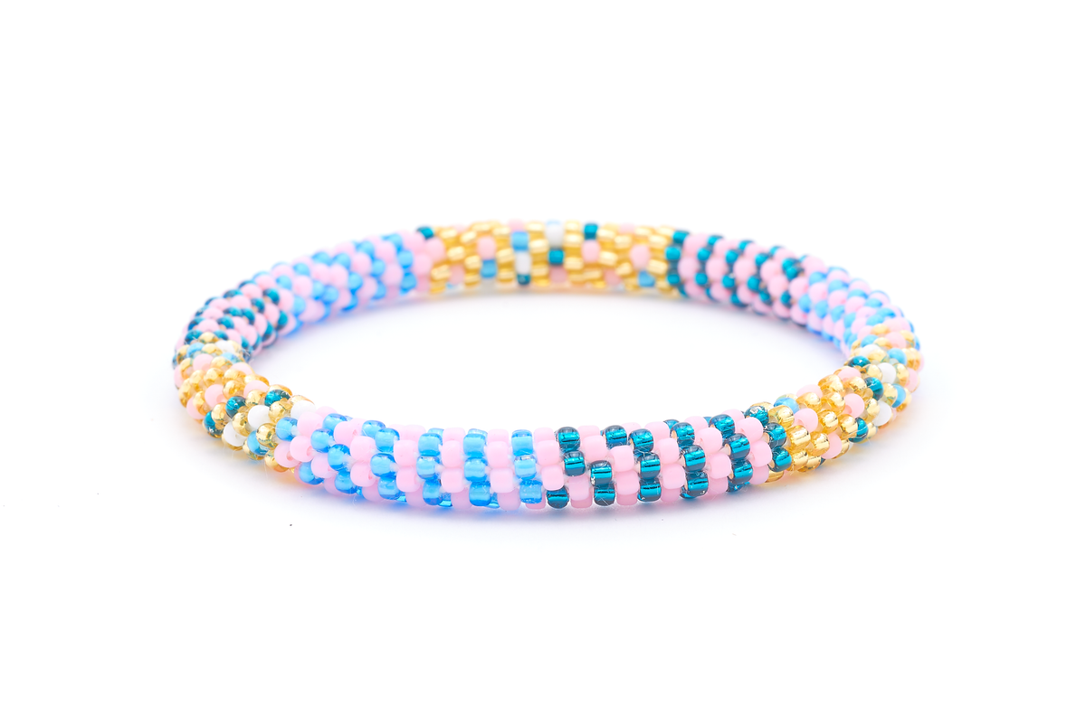 Sashka Co. handmade beaded friendship bracelet with matte light pink, teal, champagne gold, blue, and white glass beads. Crafted in Nepal by skilled artisans in a line pattern.