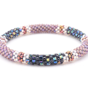 Sashka Co. handmade glass beaded friendship bracelet with matte iridescent purple, black, iridescent, clear, and iridescent plum glass beads. Crafted in Nepal by skilled artisans.