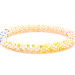 Sashka Co. handmade glass beaded friendship bracelet with peach, pink, champagne gold, purple, blue, and green glass beads. Crafted in Nepal by skilled artisans.
