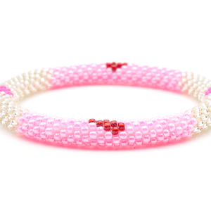 Sashka Co. handmade glass beaded friendship bracelet with pink, clear, and red glass beads in a block heart pattern. Crafted in Nepal by skilled artisans.