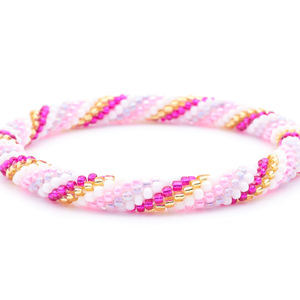 Sashka Co. handmade beaded friendship bracelet with pink, white, fuchsia, champagne gold, and light iridescent purple glass beads. Crafted in Nepal by skilled artisans in a spiral pattern.
