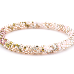 Handmade beaded friendship bracelet with plum, rose gold, and iridescent glass beads. Crafted by artisans in Nepal for Sashka Co.