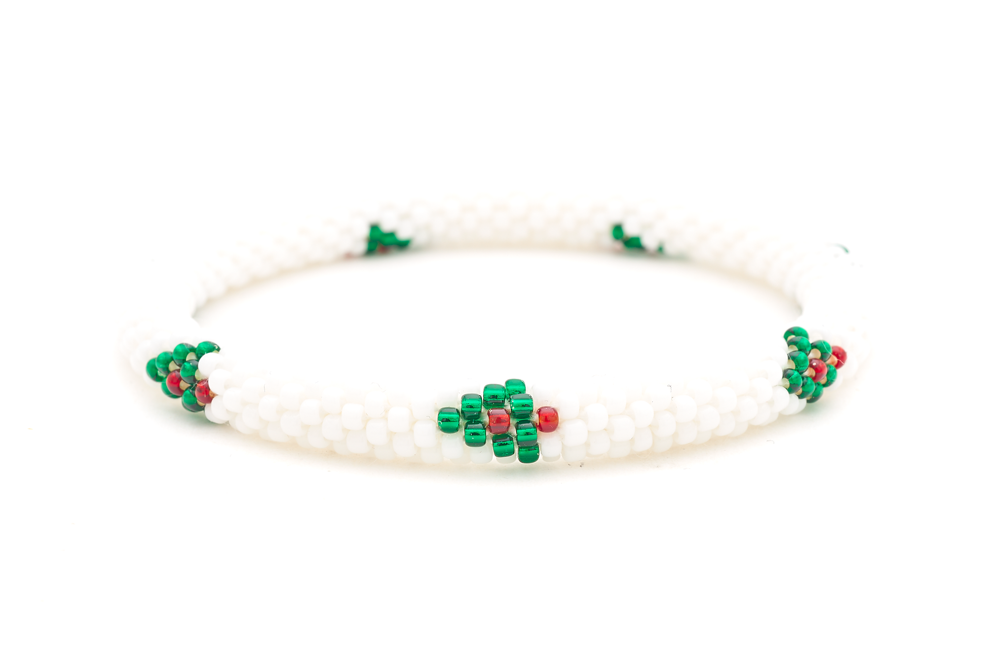 Sashka Co. handmade glass beaded friendship bracelet with red, white, and green glass beads in a festive holiday pattern. Crafted in Nepal by skilled artisans.