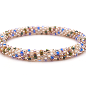 Sashka Co. handmade glass beaded friendship bracelet with rose gold and mixed iridescent glass beads in blue, green, purple, and brown in a polka dot spiral pattern. Crafted in Nepal by skilled artisans.