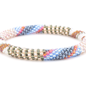 Sashka Co. handmade glass beaded friendship bracelet with silver, rose gold, blue, iridescent, and clear glass beads in a mixed pattern. Crafted in Nepal by skilled artisans.