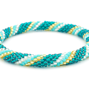 Sashka Co. handmade glass beaded friendship bracelet with teal, turquoise, champagne gold, and clear glass beads in a spiral pattern. Crafted in Nepal by skilled artisans.