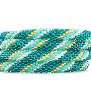 Sashka Co. handmade glass beaded friendship bracelet with teal, turquoise, champagne gold, and clear glass beads in a spiral pattern. Crafted in Nepal by skilled artisans.