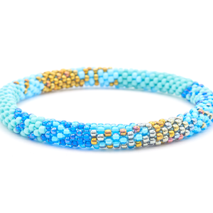 Sashka Co. handmade glass beaded friendship bracelet with turquoise, baby blue, iridescent bronze, blue, and silver glass beads. Crafted in Nepal by skilled artisans.