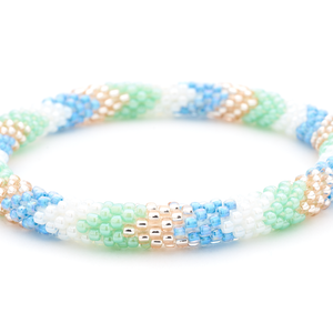Sashka Co. handmade glass beaded friendship bracelet with white, mint, blue, and rose gold glass beads in a chevron pattern. Crafted in Nepal by skilled artisans.