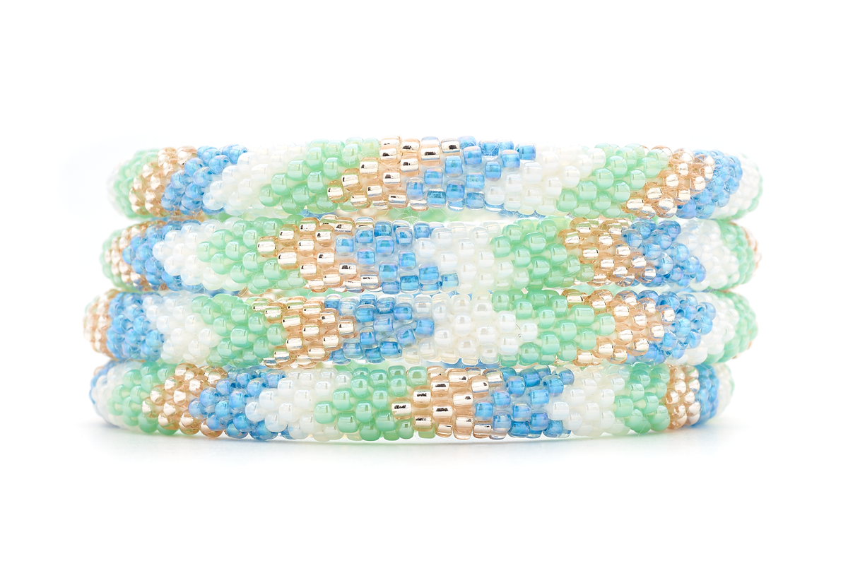 Sashka Co. handmade glass beaded friendship bracelet with white, mint, blue, and rose gold glass beads in a chevron pattern. Crafted in Nepal by skilled artisans.