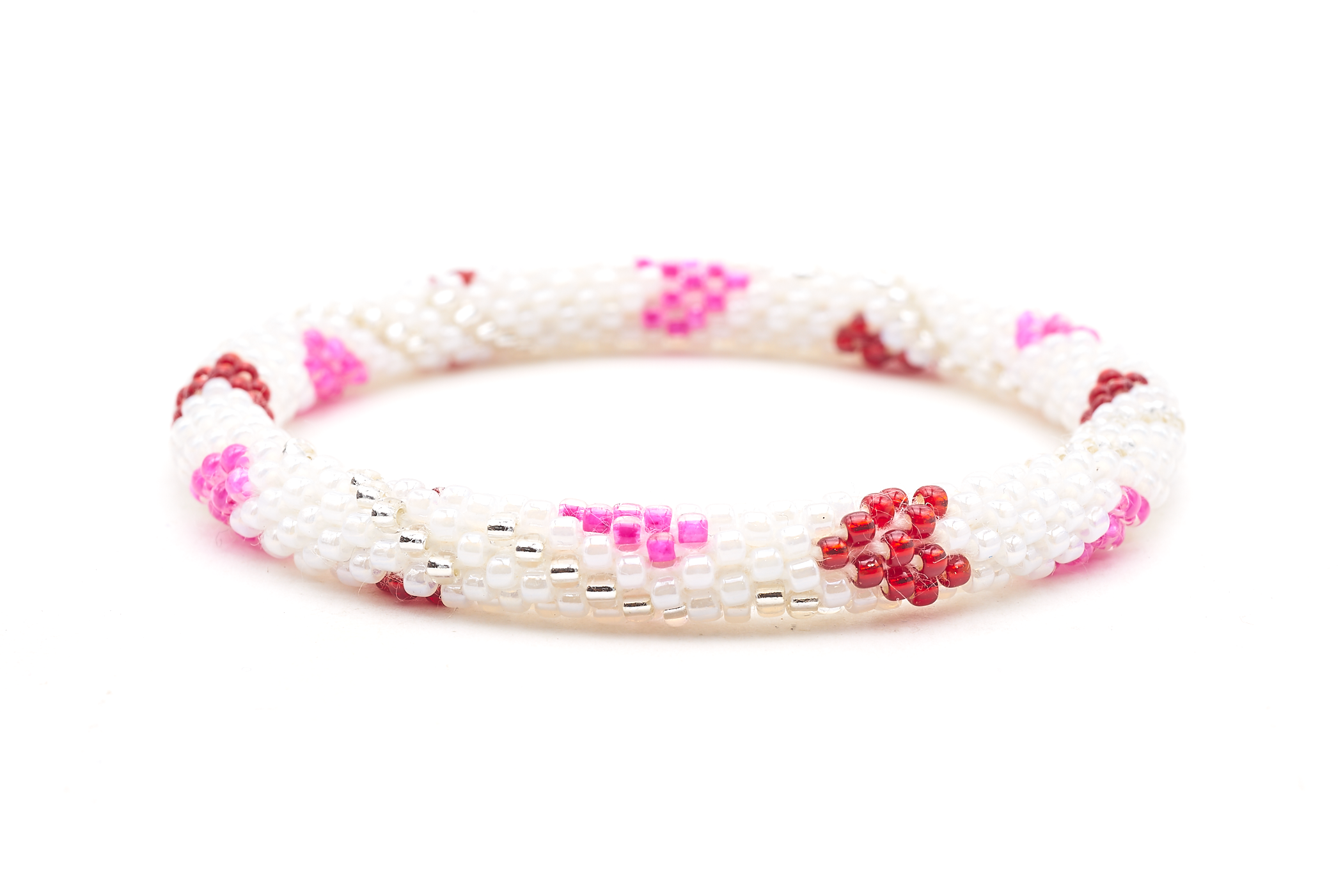 Sashka Co. handmade glass beaded friendship bracelet with white, pink, red, and clear glass beads in a heart spiral pattern. Crafted in Nepal by skilled artisans.