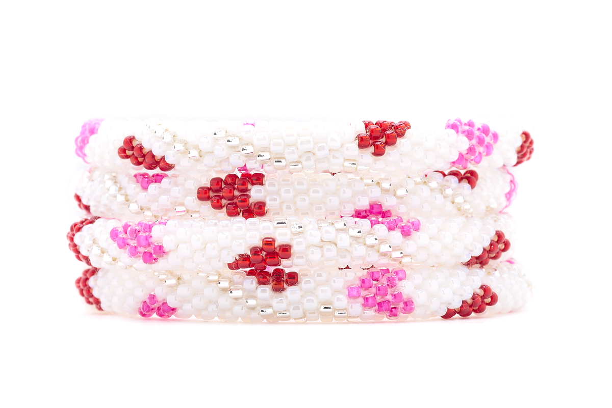 Sashka Co. handmade glass beaded friendship bracelet with white, pink, red, and clear glass beads in a heart spiral pattern. Crafted in Nepal by skilled artisans.