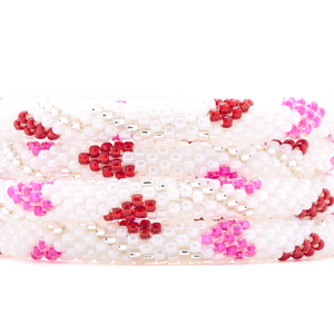 Sashka Co. handmade glass beaded friendship bracelet with white, pink, red, and clear glass beads in a heart spiral pattern. Crafted in Nepal by skilled artisans.