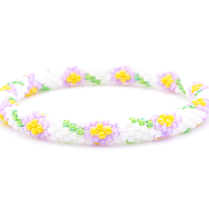 Sashka Co. handmade glass beaded friendship bracelet with white, purple, green, and yellow glass beads. Crafted in Nepal by skilled artisans.