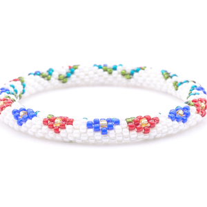 Sashka Co. handmade glass beaded friendship bracelet with white, red, blue, green, teal, and champagne gold glass beads. Crafted in Nepal by skilled artisans.