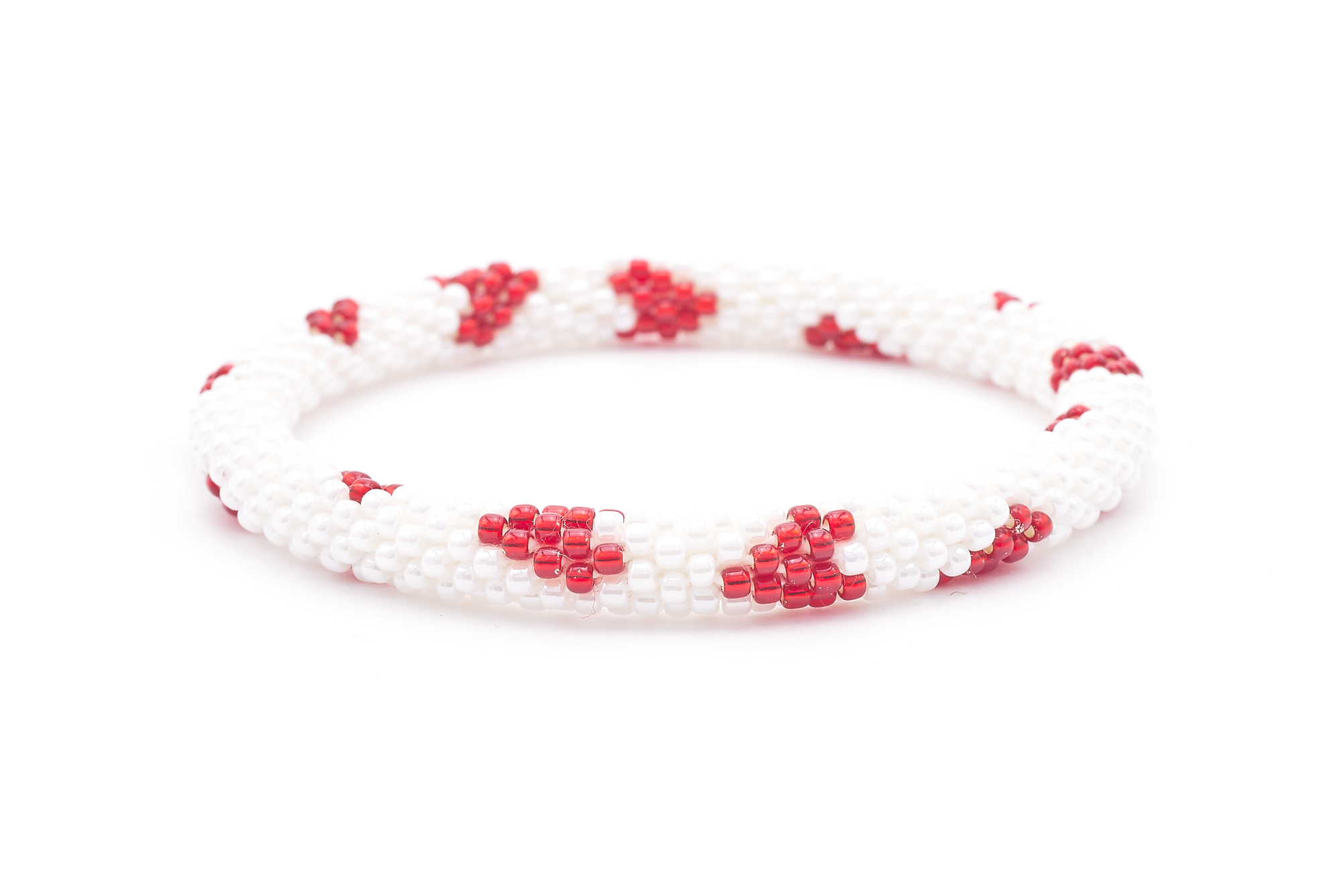 Sashka Co. handmade glass beaded friendship bracelet with white and red glass beads in a hearts pattern. Crafted in Nepal by skilled artisans.