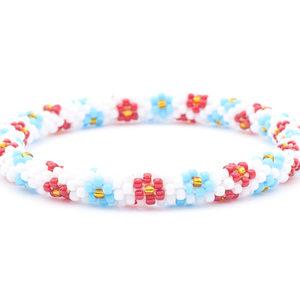Sashka Co. handmade glass beaded friendship bracelet with white, red, light blue, and gold glass beads. Crafted in Nepal by skilled artisans.