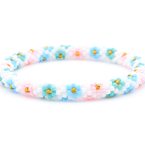 Sashka Co. handmade glass beaded friendship bracelet with white, turquoise, baby blue, pink, and gold glass beads. Crafted in Nepal by skilled artisans.
