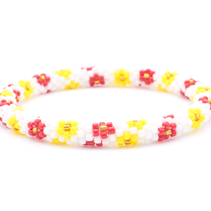 Sashka Co. handmade glass beaded friendship bracelet with white, yellow, red, and gold glass beads. Crafted in Nepal by skilled artisans.