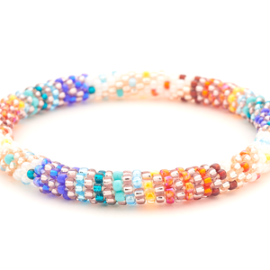 Sashka Co handmade beaded friendship bracelet with a colorful line spiral pattern in white, red, orange, blue, rose gold, teal, and turquoise.

