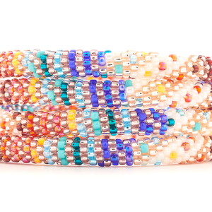 Sashka Co handmade beaded friendship bracelet with a colorful line spiral pattern in white, red, orange, blue, rose gold, teal, and turquoise.


