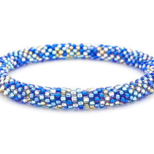 Sashka Co handmade beaded friendship bracelet with blue, champagne gold, clear, and confetti glass beads. Crafted in Nepal by skilled artisans in a unique radiant pattern.

