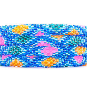 Sashka Co handmade beaded friendship bracelet with blue, teal, neon pink, and orange glass beads. Crafted in Nepal by skilled artisans in a diamond pattern.