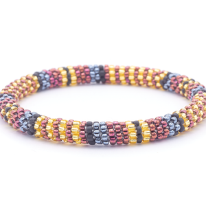 Sashka Co. handmade beaded friendship bracelet with champagne gold, matte black, silver, and iridescent maroon line pattern. Crafted in Nepal by skilled artisans.
