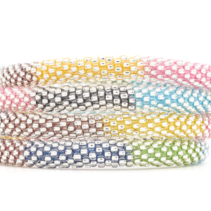 Sashka Co handmade beaded friendship bracelet with clear beads and mixed thread in a block pattern. Crafted in Nepal by skilled artisans.