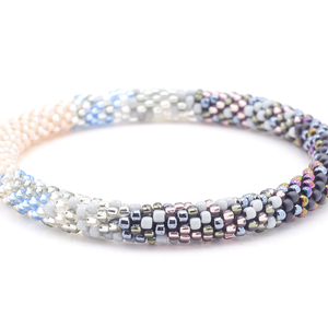 Sashka Co handmade beaded friendship bracelet with clear, silver, light peach, matte black, iridescent, gray, and light blue glass beads. Crafted in Nepal by skilled artisans in a confetti blend pattern.