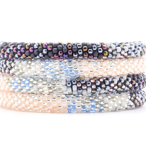 Sashka Co handmade beaded friendship bracelet with clear, silver, light peach, matte black, iridescent, gray, and light blue glass beads. Crafted in Nepal by skilled artisans in a confetti blend pattern.