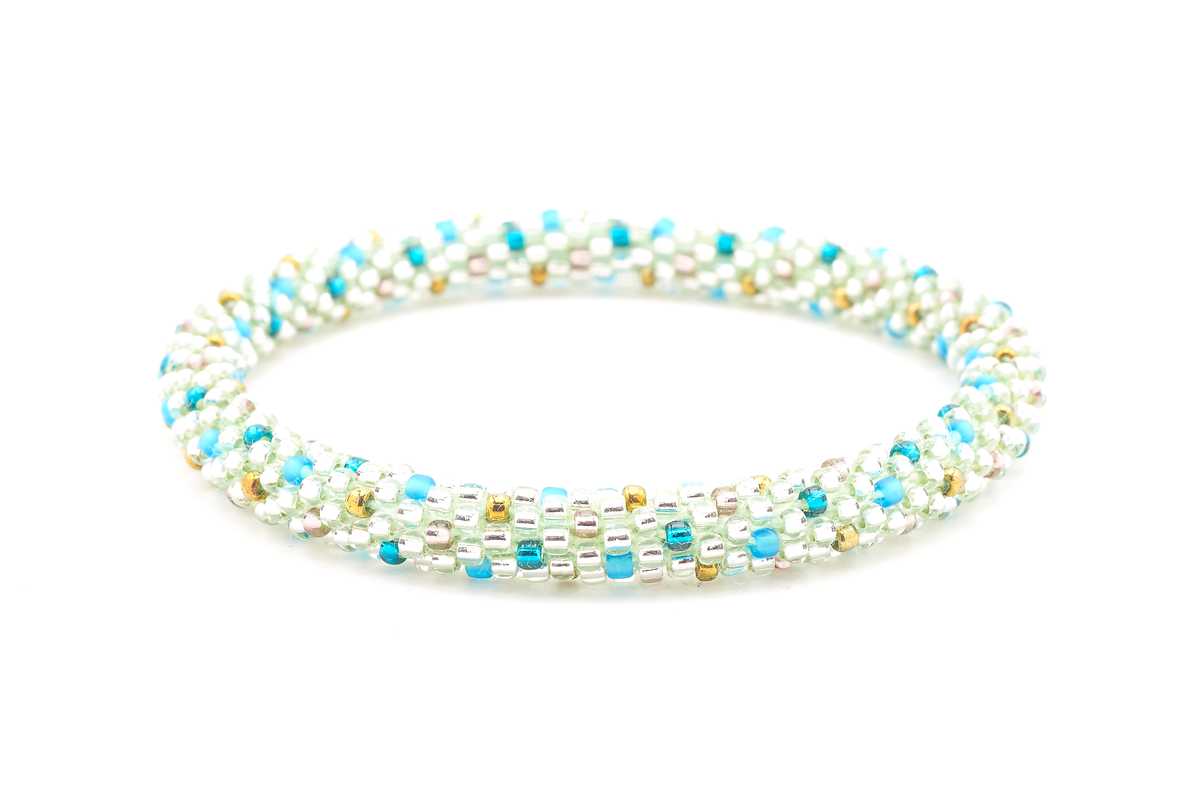 Sashka Co handmade beaded friendship bracelet with clear, teal, matte blue, purple, and bronze glass beads. Crafted in Nepal by skilled artisans in a polka dot pattern.